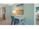 Cozy home office space with a stylish desk, chair, and view into the kitchen and the adjacent bedroom at 1840 India Palm Dr, Edgewater, FL 32141