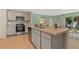 Spacious kitchen showcases stainless steel appliances, a center island, and an open view of the living area at 1840 India Palm Dr, Edgewater, FL 32141