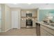 A well-equipped kitchen features stainless steel appliances, light cabinetry, and modern countertops at 1840 India Palm Dr, Edgewater, FL 32141