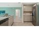 Modern kitchen boasts stainless steel appliances, and a view to the hallway and the adjacent living area at 1840 India Palm Dr, Edgewater, FL 32141