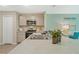 Bright kitchen with stainless steel appliances, stylish cabinets, and view into the home office area at 1840 India Palm Dr, Edgewater, FL 32141