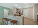 Open kitchen features a breakfast bar with seating, stainless steel appliances, and modern cabinets at 1840 India Palm Dr, Edgewater, FL 32141
