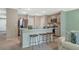 Bright kitchen features an island with stool seating and stainless steel appliances, offering a modern design at 1840 India Palm Dr, Edgewater, FL 32141