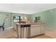 Open kitchen featuring stainless steel appliances, a breakfast bar, and view into the living area at 1840 India Palm Dr, Edgewater, FL 32141