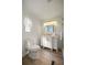 Bright bathroom with a white vanity, modern fixtures, and luxury vinyl flooring at 906 Beechwood Ave, Lady Lake, FL 32159