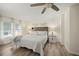 Serene bedroom with a neutral color palette, a ceiling fan, and wood-look flooring at 906 Beechwood Ave, Lady Lake, FL 32159
