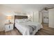 Neutral bedroom features luxury vinyl floors, a ceiling fan, and a decorative headboard at 906 Beechwood Ave, Lady Lake, FL 32159