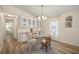 Charming dining area with a glass table, decorative lighting, and built-in cabinets at 906 Beechwood Ave, Lady Lake, FL 32159
