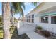 Exterior view of the deck with seating and tropical landscaping at 906 Beechwood Ave, Lady Lake, FL 32159