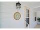 Home's front door with an outdoor light fixture and nautical décor at 906 Beechwood Ave, Lady Lake, FL 32159