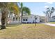 Charming single story home with well-maintained lawn and tropical landscaping at 906 Beechwood Ave, Lady Lake, FL 32159