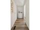 Bright hallway with a white chest of drawers, luxury vinyl flooring, and white walls at 906 Beechwood Ave, Lady Lake, FL 32159