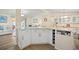 Bright kitchen featuring white cabinetry, modern countertops, and a convenient wine rack at 906 Beechwood Ave, Lady Lake, FL 32159