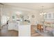 Open-concept kitchen and dining area with granite countertops and stylish furnishings at 906 Beechwood Ave, Lady Lake, FL 32159