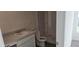 Well-lit bathroom with a shower, toilet, vanity, and modern fixtures, creating a clean and functional space at 521 Cardinal Dr, Poinciana, FL 34759