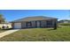 Charming single-story home featuring a well-maintained lawn, an attached garage, and a welcoming front entrance at 521 Cardinal Dr, Poinciana, FL 34759