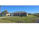 Single-story home features a well-manicured lawn and attached one car garage at 521 Cardinal Dr, Poinciana, FL 34759