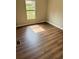 Bedroom with dark wood flooring and a window that provides natural light at 3123 Crystal Hills Dr, Lakeland, FL 33801