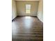 Bedroom with a window offering natural light and wood-look flooring at 3123 Crystal Hills Dr, Lakeland, FL 33801