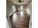 Spacious bedroom with wood-look flooring, neutral paint, and two windows at 3123 Crystal Hills Dr, Lakeland, FL 33801