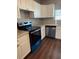 Well-lit kitchen with white cabinets, stainless steel dishwasher, oven, and speckled countertops at 3123 Crystal Hills Dr, Lakeland, FL 33801