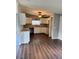 Spacious kitchen with white cabinets, laminate countertops, ceiling fan, and wood-look flooring at 3123 Crystal Hills Dr, Lakeland, FL 33801