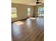 Open-concept living area with wood-look flooring, ceiling fan, and natural light at 3123 Crystal Hills Dr, Lakeland, FL 33801