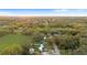 An aerial view of a neighborhood reveals lush, mature trees, expansive green spaces, and a peaceful residential community at 3800 Levins Rd, Mulberry, FL 33860