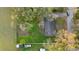 Aerial shot of a home highlighting its well-maintained lawn, mature trees, and a fenced backyard at 3800 Levins Rd, Mulberry, FL 33860