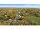 Wide aerial view of a residential area featuring lush trees and a green field at 3800 Levins Rd, Mulberry, FL 33860