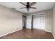 A bedroom features hardwood floors, a ceiling fan, a closet, and access to an en-suite bathroom at 3800 Levins Rd, Mulberry, FL 33860