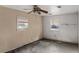 A bedroom with two windows and damaged walls at 3800 Levins Rd, Mulberry, FL 33860