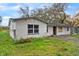 Close up on a home showcasing a painted white brick exterior and large front windows at 3800 Levins Rd, Mulberry, FL 33860