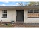 Exterior front entry featuring a painted white brick exterior and a solid dark-colored front door at 3800 Levins Rd, Mulberry, FL 33860