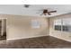 Living room featuring tile flooring, neutral-colored walls, and a window overlooking the side yard at 3800 Levins Rd, Mulberry, FL 33860