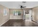 Living room featuring tile flooring, neutral-colored walls, and a large window overlooking the front yard at 3800 Levins Rd, Mulberry, FL 33860
