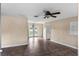 Living room featuring neutral-colored walls and tile flooring leading out to French doors at 3800 Levins Rd, Mulberry, FL 33860