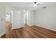 Bedroom featuring wood-look floors and multiple access doors at 26922 White Plains Way, Leesburg, FL 34748