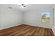 Bedroom featuring wood-look floors, a ceiling fan, and natural light from the window at 26922 White Plains Way, Leesburg, FL 34748