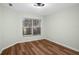 Cozy bedroom with wood-look floors and natural light from the window at 26922 White Plains Way, Leesburg, FL 34748