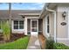 Inviting entryway features a screened-in porch and well-maintained landscaping at 26922 White Plains Way, Leesburg, FL 34748