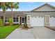 Inviting home exterior features a well-manicured lawn and attached two-car garage at 26922 White Plains Way, Leesburg, FL 34748