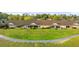 Charming single story exterior featuring a well-maintained green lawn and ample parking at 26922 White Plains Way, Leesburg, FL 34748