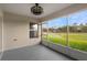 Screened lanai with ceiling fan and views of community green space at 26922 White Plains Way, Leesburg, FL 34748