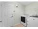 Bright laundry room with washer, dryer, and ample storage at 26922 White Plains Way, Leesburg, FL 34748