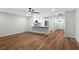 Open-concept living room flows into the kitchen, features hardwood floors at 26922 White Plains Way, Leesburg, FL 34748