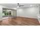 Open living room features hardwood floors and sliding doors to outdoor patio at 26922 White Plains Way, Leesburg, FL 34748