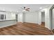 Bright living room is open to kitchen area and features sleek hardwood floors at 26922 White Plains Way, Leesburg, FL 34748