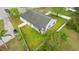 Aerial view of a house with a fenced backyard and a car parked in the driveway, surrounded by green grass and trees at 580 Tree Shore Dr, Orlando, FL 32825