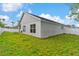 Exterior of home showing the yard, windows, and fence on a sunny day at 580 Tree Shore Dr, Orlando, FL 32825